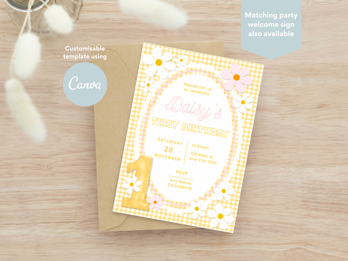 Yellow and PInk Daisy themed customisable first birthday party invitation. A first birthday invitation card with a yellow gingham border, white daisy flowers, and a large yellow number 1, shown on top of a kraft envelope on a light wood surface. Text overlays mention Canva and customizable template use.