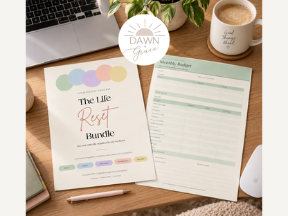 A styled flat-lay of a printable planner bundle titled 'The Life Reset Bundle' by Dawn Grace, displayed on a wooden desk alongside a laptop, mug, plant, and other desk accessories.